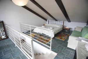 an attic room with a bed and a couch at Apartments DDD in Baška