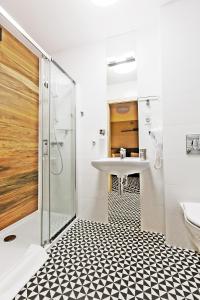 a bathroom with a sink and a shower at Villa Nova in Białystok