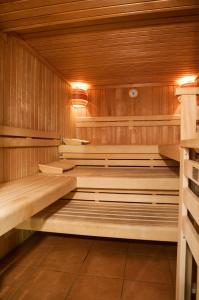 an empty sauna with wooden walls and floors and lights at LIHO - einfach Lübeck in Lübeck