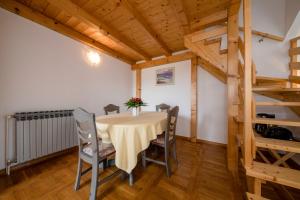 a dining room with a table and chairs at Apartments Dedić in Supetarska Draga