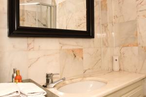 a bathroom with a sink and a mirror at Genesis Voorschoten in Voorschoten +20 photos