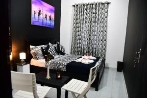 a bedroom with a bed and a table and chairs at One and Only Apartment in Negombo