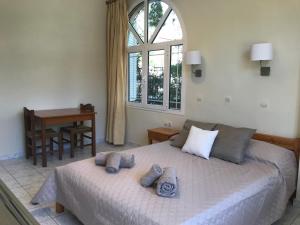 a bedroom with a bed with towels on it at Calypso Beach Hotel in Loutra Edipsou