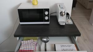 a microwave sitting on top of a table at Antonio Appartement in Steinabrückl