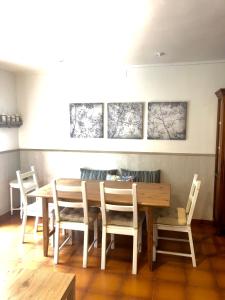 a dining room with a wooden table and chairs at La casa de las Ardillas in Benasque +28 photos