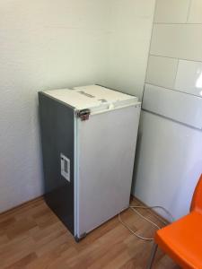 a small refrigerator sitting in a corner of a room at Rana's Zimmervermittlung 2 in Bremen