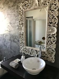 a bathroom with a white sink and a mirror at Castel Apartment in Castellamonte