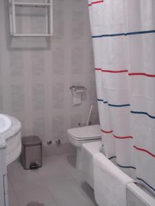 een badkamer met een toilet en een douchegordijn bij Stella Maris - Fuengirola in Fuengirola