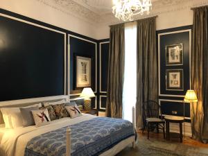 a bedroom with a large bed and a chandelier at Casa Oliver Boutique B&B - Principe Real in Lisbon