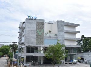 a building with a sign on the side of it at Vivid A Boutique Hotel in Tiruchchirāppalli