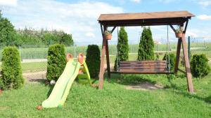 a playground with a gazebo and a slide and a bench at Apartament Blekit Nieba in Tykocin