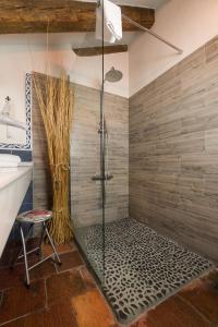 a bathroom with a shower with a glass door at Posada Real Mingaseda in Navafría