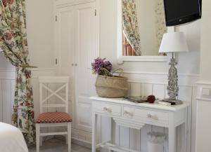1 dormitorio con mesa, lámpara y silla en Basic Hotel Puerta de Sevilla, en Sevilla