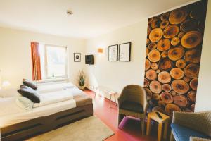 a bedroom with a bed and a large wall of logs at Ostel Jugendhotel Bremervörde in Bremervörde +57 photos