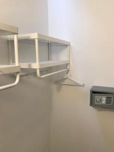 a shelf in a room with a clock on the wall at Artdeco in Lecco