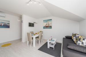 a living room with a couch and a table at Apartments HIPERION in Zadar