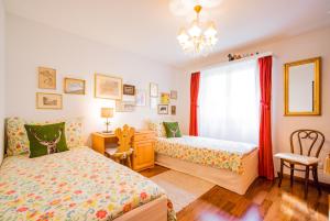 a bedroom with two beds and a window at Chesa Murmina No. 1 in Zuoz