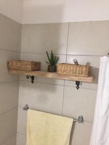 a bathroom with two baskets and a towel at Stefanel View-Frederika in Himare