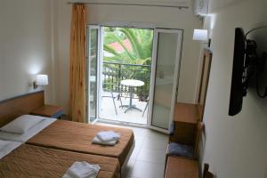 Postel nebo postele na pokoji v ubytování Metaxa Hotel