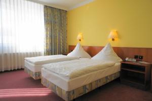 Postel nebo postele na pokoji v ubytování Hotel Pesterwitzer Siegel