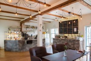 a restaurant with a table and chairs and a counter at Hotelli Aittaranta in Uusikaupunki