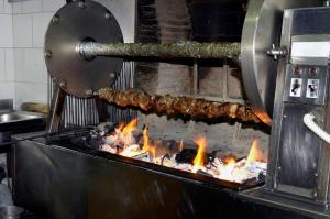 a grill with some meat being cooked on fire at Buca di Michelangelo in Caprese Michelangelo