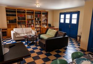 a living room with two couches and a blue door at Theo's house in Chora! in Andros