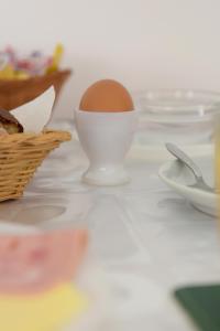 a egg in a white bowl on a table at Trianta Hotel Apartments in Ialyssos