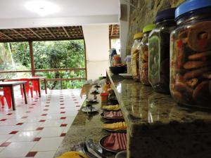 a counter in a room with jars of food at Pousada do Horto in Trindade