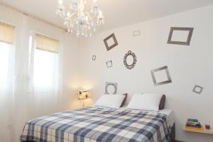 a bedroom with a bed with a checkered blanket at City Beach Apartment in Split