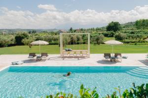 a woman is swimming in a swimming pool at La Chiave Bianca in Miglianico