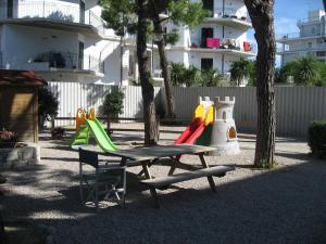 a park with a picnic table and a playground at Residence Dolce Vita in San Benedetto del Tronto