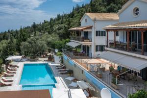 a view of a hotel with a swimming pool at Liogerma Villas in Agios Nikitas