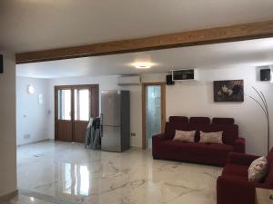 a living room with a couch and a refrigerator at Virgen del Carmen in Abades