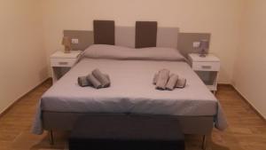 a bedroom with a large bed with two night stands at Via Barocci 34 in Urbino
