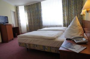 Postel nebo postele na pokoji v ubytování Hotel Pesterwitzer Siegel