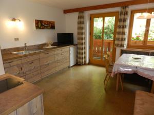 a kitchen with a sink and a table and a window at Gedrarzerhof in Luson