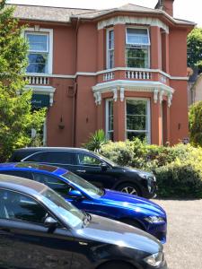 a house with cars parked in front of it at The Westbank in Torquay