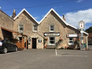 a brick building with a car parked in front of it at The George Inn in Wells