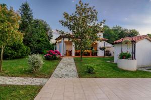 a house with a walkway in front of a yard at Apartments Ana in Pula