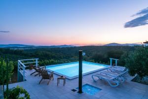 a swimming pool with a view of the mountains at Villa Andante in Trogir