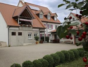 a large house with red roofs and a driveway at Ferienwohnung Bickel in Absberg