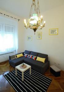 a living room with a couch and a table at Palma Apartment in Zagreb