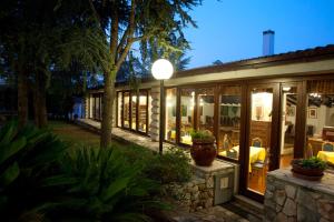a house with glass doors and a patio at night at Corallo Country House in Noci