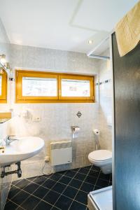 a bathroom with a sink and a toilet at Ferienhof Hoffmann in Weissensee