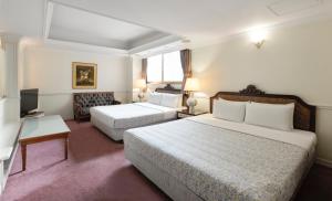 Ένα ή περισσότερα κρεβάτια σε δωμάτιο στο Forbes Hotel