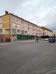 a large building on a city street with a traffic light at Lara in Doboj +18 photos