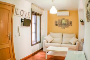 a living room with a couch and a window at Calle Santa Marina 6 in Seville