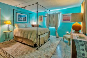 a blue bedroom with a bed and a chair at Rancho Deluxe in Twentynine Palms
