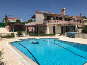 a large swimming pool in front of a house at Terra Relaxa in Loutraki